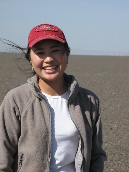 Woman in red baseball cap smiling for the camera