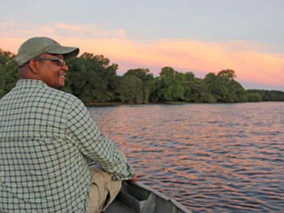 Stuart on a boat on the water during sunset