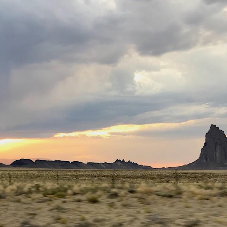 Northern Arizona plains with rocky formation in background